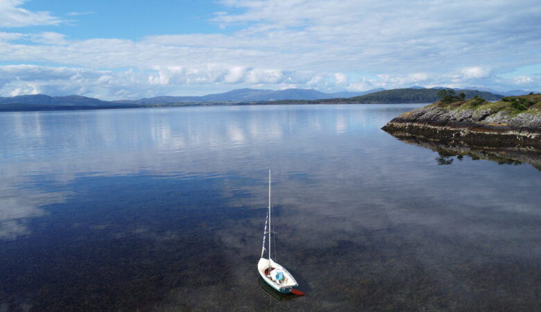 A drone image of our sailing dinghy in a bay near Oban, Scotland