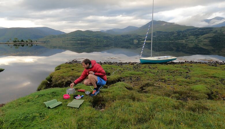 Peter is cooking breakfast on a petrol stove in Loch Etive
